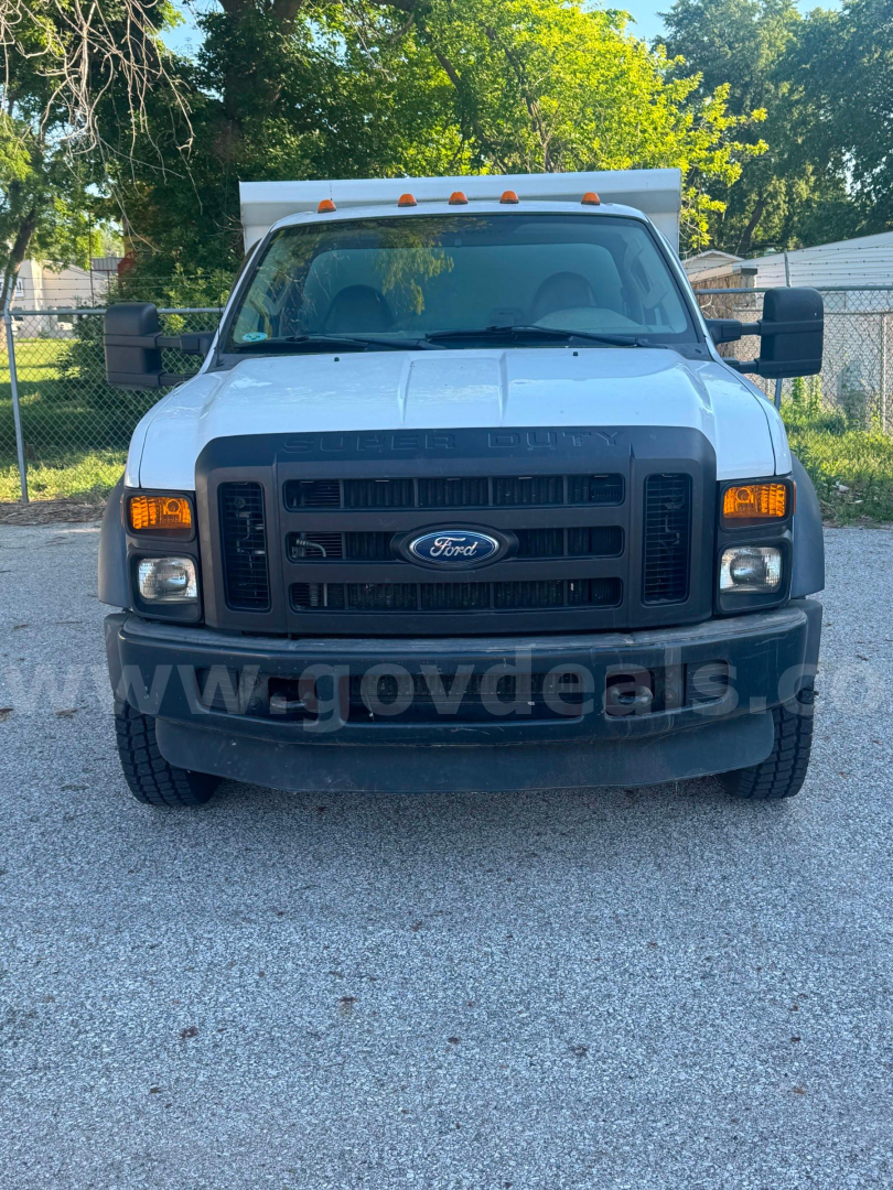 Ford F-550 dump truck front view showing grille, headlights, and bumper with Ford emblem.