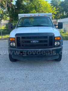 Ford F-550 dump truck front view showing grille, headlights, and bumper with Ford emblem.