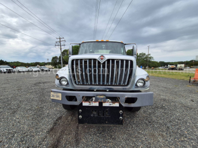 Front view of 2017 International 7400 garbage truck showing grille, headlights, and bumper with license plate area