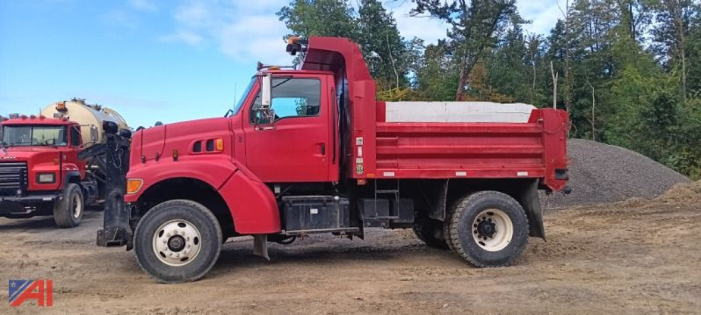 Dump truck side view showing red Ford L8511 dump bed with black chassis and white cab accents, Louisville 111 listing, VIN plate not legible.