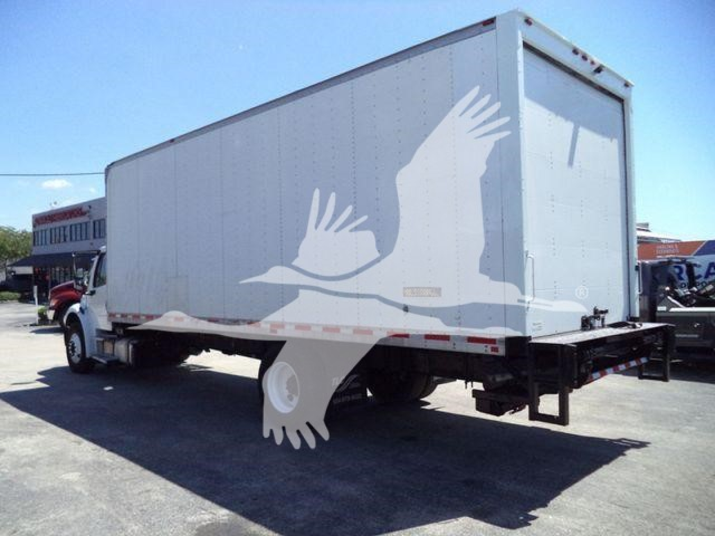Freightliner M2 106 box truck rear/side view showing cargo box and rear bumper; VIN 3ALACWFCXJDKA9609 and stock number 26803R may be present in listing.