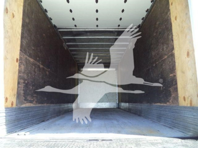 Truck cargo area interior of a 2018 Freightliner M2 106 box truck showing empty wooden side walls and metal floor.