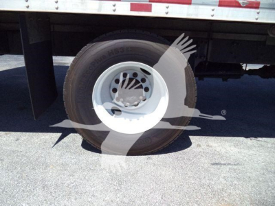 Front-wheel area of a 2018 Freightliner M2 106 box truck showing a white steel wheel and tire with logos/markings partially visible.