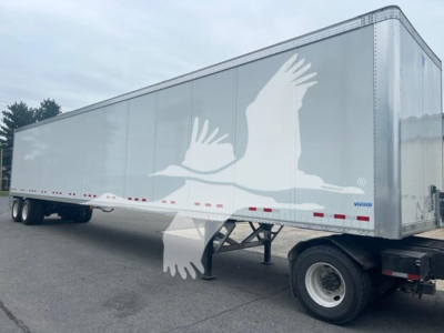 Vanguard VXP plate van trailer showing side profile with large white bird graphic and wheels, VIN 5V8VC5326VM605628 visible on listing.