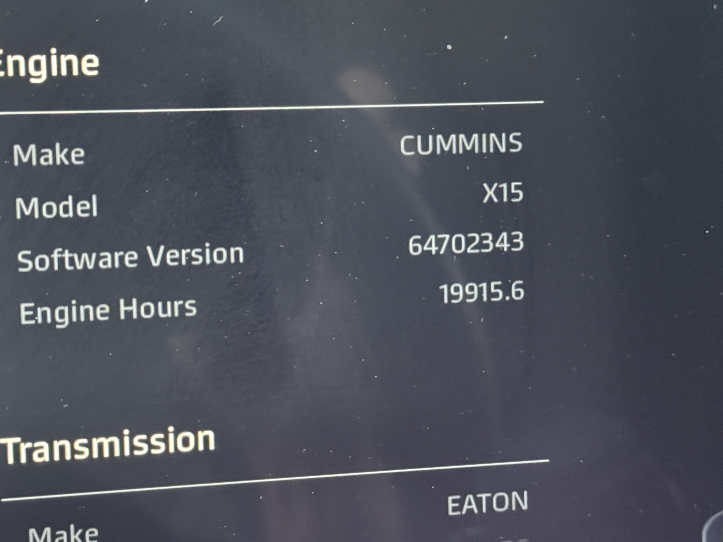 Truck engine data panel showing Cummins X15 engine make and engine hours 19915.6 with software version 64702343 and transmission by Eaton.