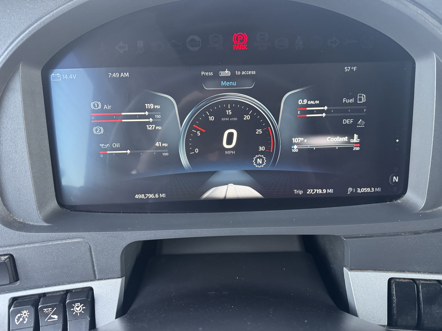 Digital instrument cluster display showing speedometer at 0 MPH, with trip data and fuel gauges in a Kenworth T680 cabin.