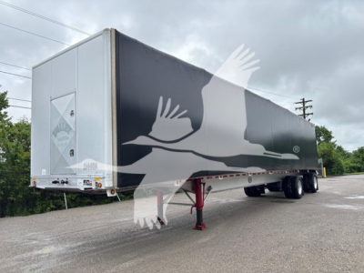Trailer in-service view showing Curtainside trailer with white rear ramps and black side panels.