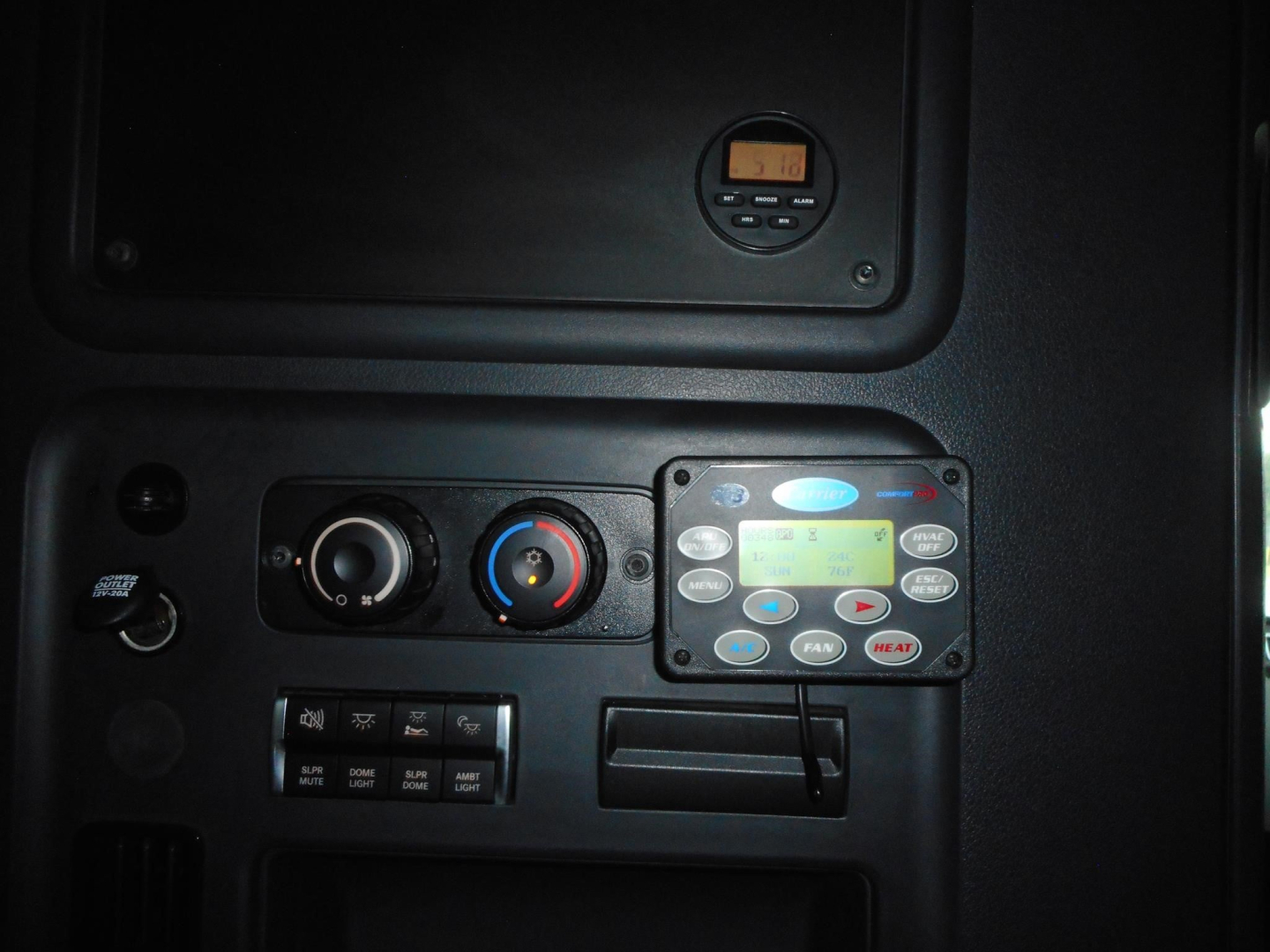 Truck dashboard panel showing climate controls and digital display in Freightliner Cascadia cab.
