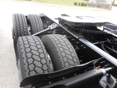 Tractor-trailer rear chassis with dual rear axles and tires, Freightliner Cascadia 126 chassis view showing tandem axle setup and frame rails.