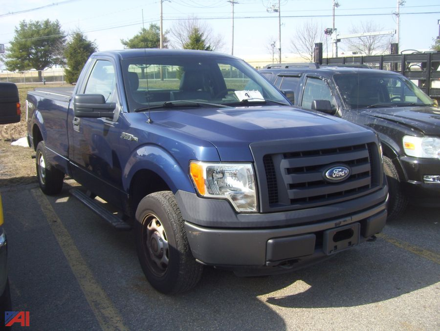 Ford F-150 pickup truck 2011 4x4 in blue front-left view showing grille and headlights