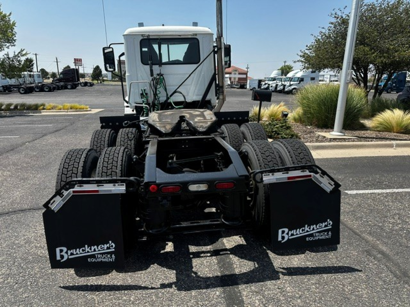 Truck view showing rear of a 2020 Mack ANTHEM daycab tractor with dual rear axles, mud flaps labeled Bruckner’s Equipment, and fifth wheel area visible.