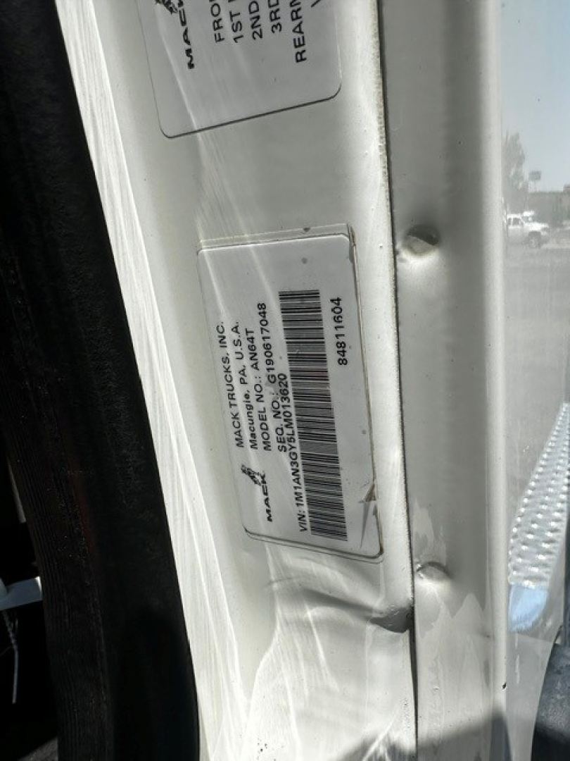 Tag on Mack Anthem door jamb with VIN label and barcode near door frame.