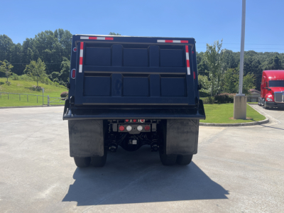 Kenworth dump truck rear view showing dump bed and rear axle assembly.