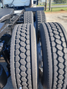 Truck rear duals on Freightliner PT126064S chassis showing tread patterns and wheel rims.