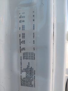 Truck data plate showing manufacturer details, max axle ratings, and other specs for a Freightliner PT126064S T. Text includes CAPACITY, GROSS vehicle weight, and serial numbers.