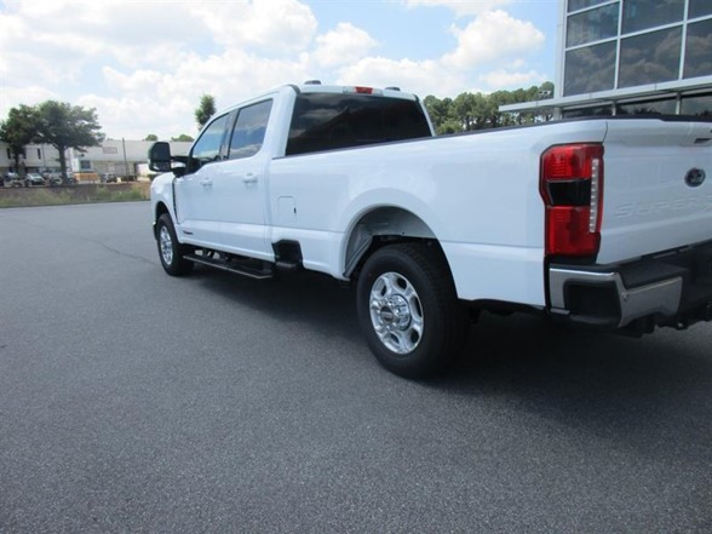 Ford F-250 pickup truck rear three-quarter view showing white body and chrome exhaust, 2WD, stock number 336531.