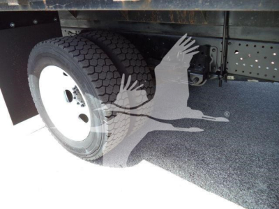 Isuzu NPRR 2019 flatbed truck wheel well and undercarriage showing dual rear wheels and chassis components.