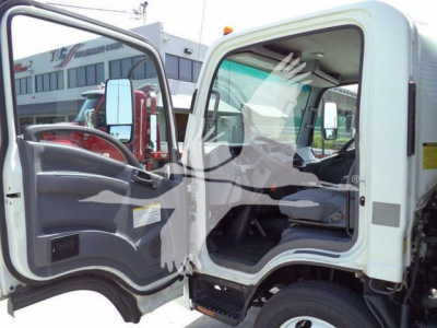 Isuzu NPR/NRR cab interior view with open driver door and view of dashboard; light-colored cab on a flatbed/dump truck.