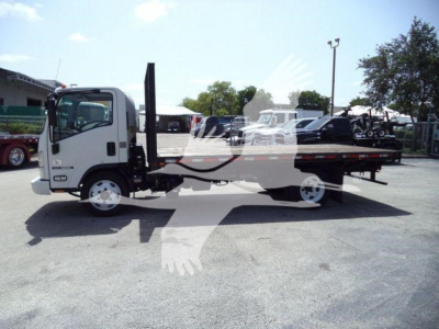 Isuzu NPR-style flatbed tow truck with loading ramp and flatbed, side view.