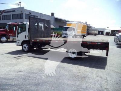 Isuzu NPR/flatbed dump truck in side view showing flatbed with metal rails and cab, stock number T00722, VIN JALE5W165K7300722, in a dealership lot.
