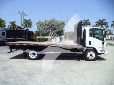 Isuzu NRR flatbed tow truck side view showing flatbed bed with loading ramps and dual rear wheels.