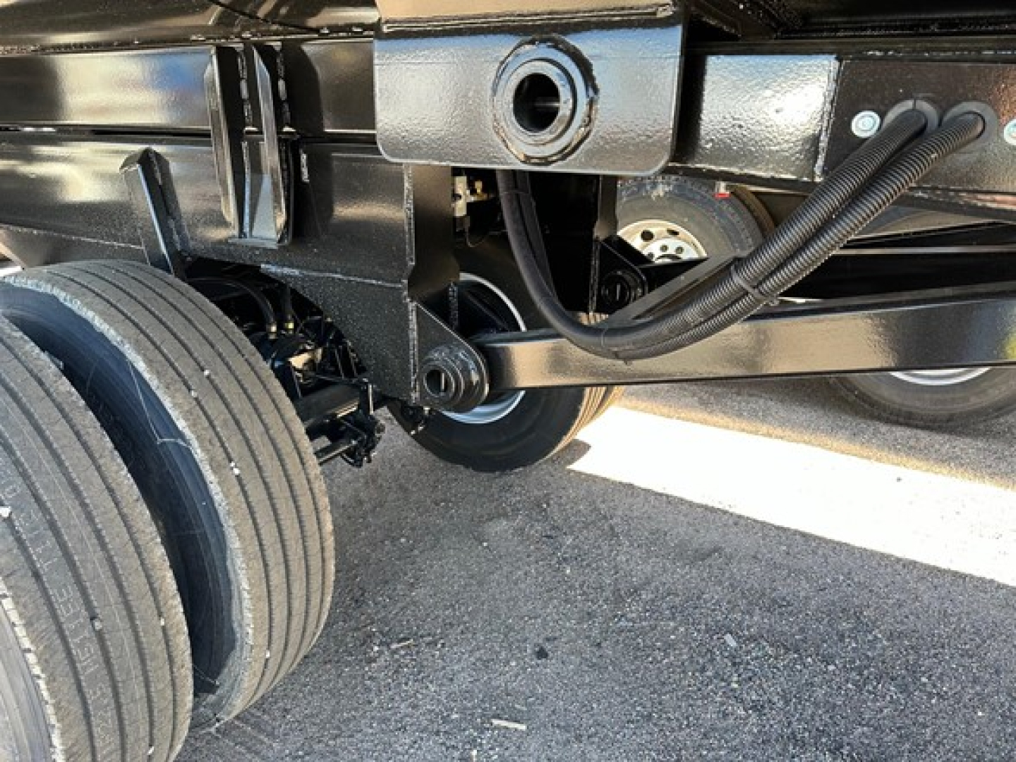 Trailer undercarriage showing frame and suspension components of a new 2025 Ranco Anvil Steel Quarter Frame End Dump.