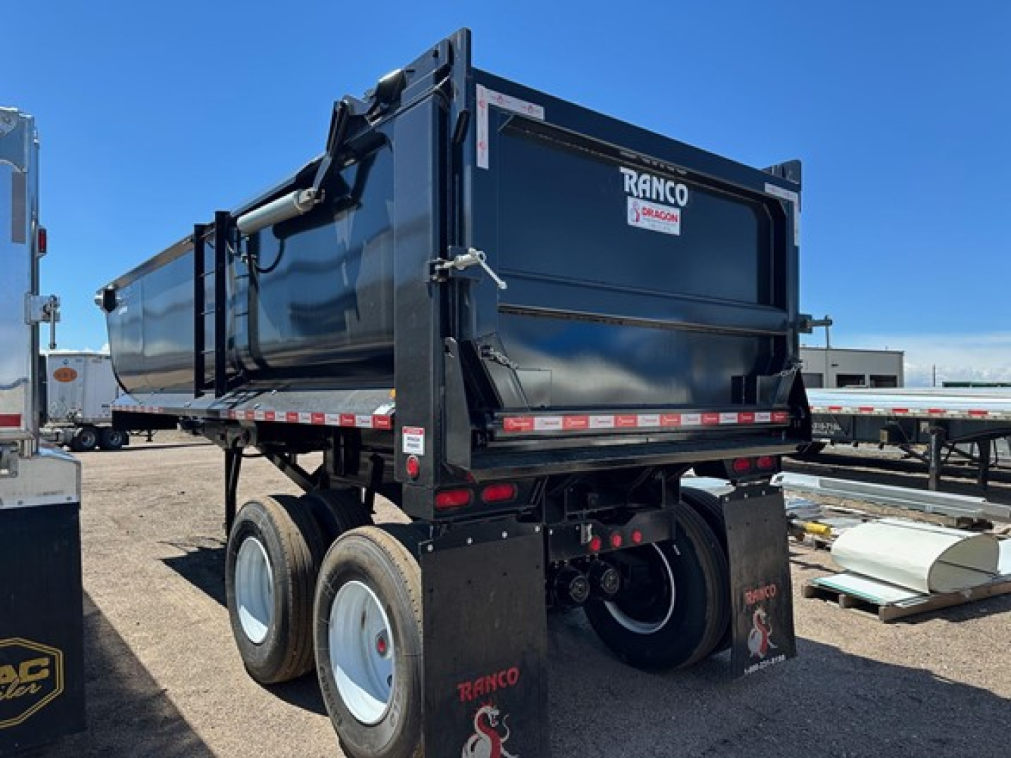 Ranco Anvil Steel Quarter Frame End Dump trailer showing RANCO logo on tailgate and dual rear wheels.