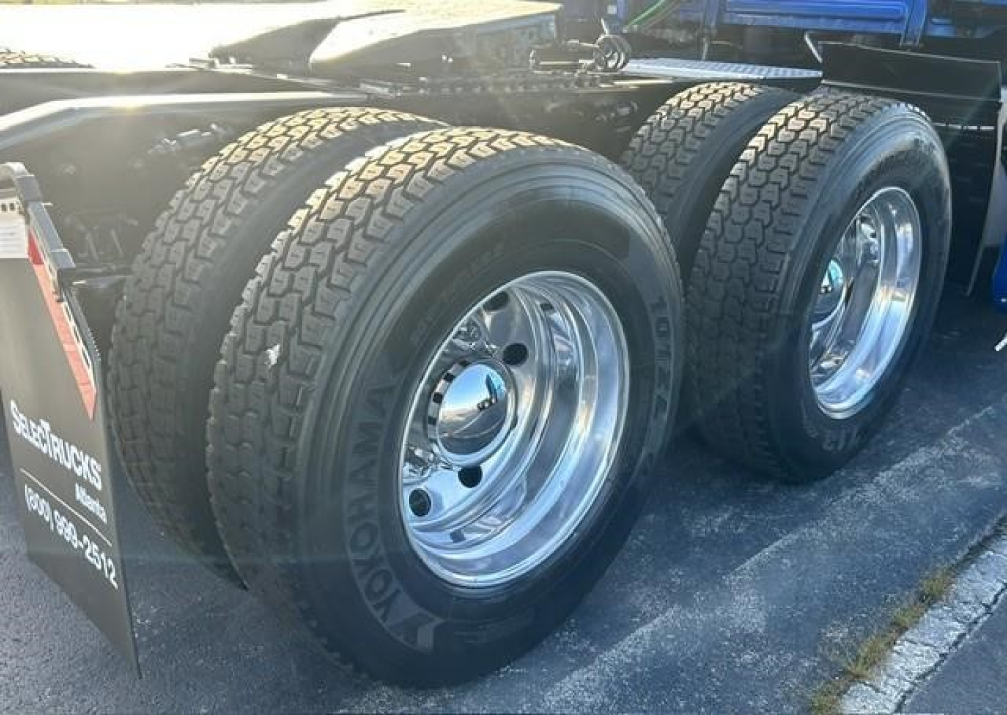 Freightliner Cascadia 126 dual rear axle with chrome wheels and Goodyear tires. Part of a sleeper truck chassis, visible fuel/air lines and wheel wells.