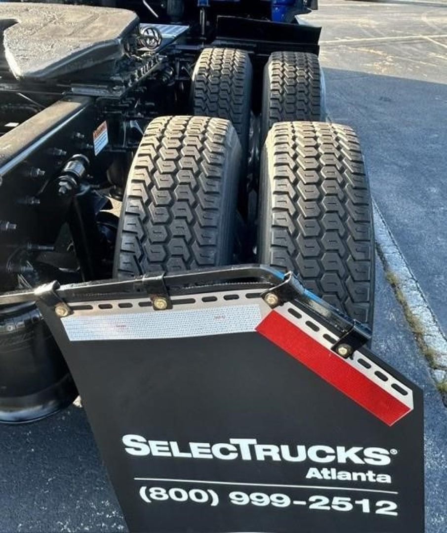 Freightliner Cascadia 126 rear dual-axle wheels showing SelectTrucks Atlanta plate and contact number.