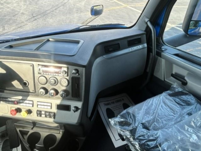 Cab interior of a 2022 Freightliner Cascadia 126 truck showing dashboard controls and steering area.