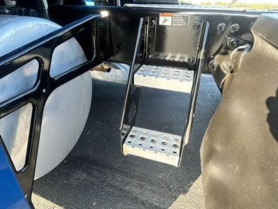 Freightliner Cascadia 126 undercarriage showing metal steps and frame.