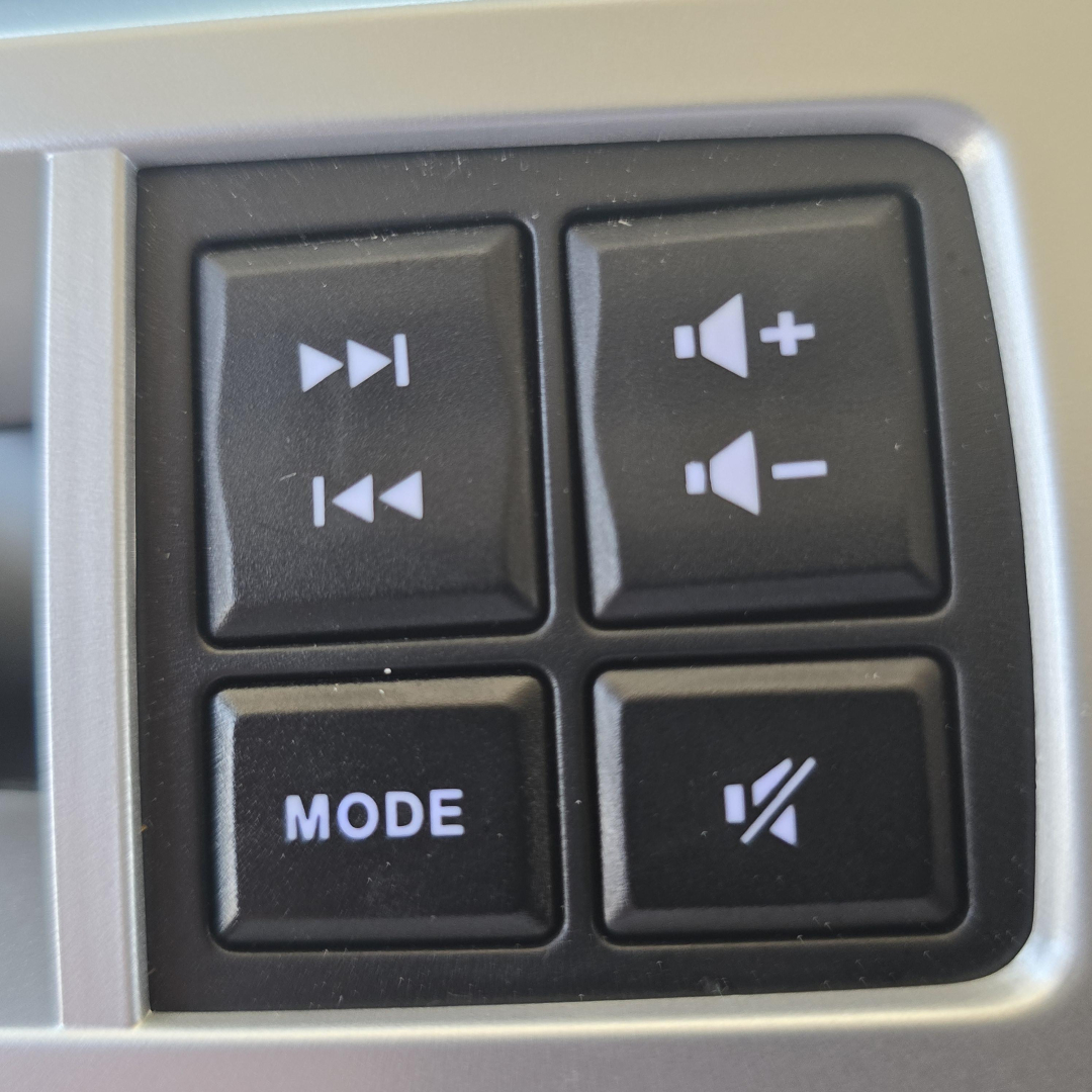 Control panel on Mack PI64 showing playback buttons, volume up/down, mode button, and mute switch.