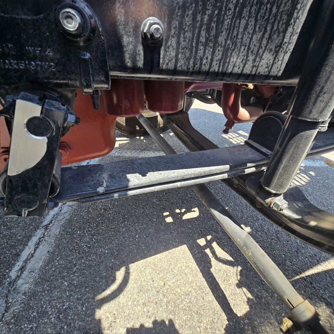 Mack PI64 truck undercarriage showing hydraulic components and frame rails