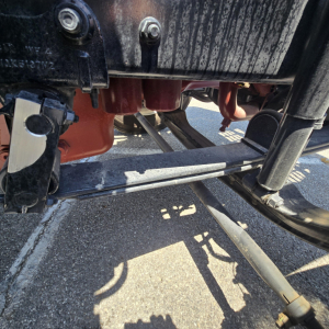 Mack PI64 truck undercarriage showing hydraulic components and frame rails