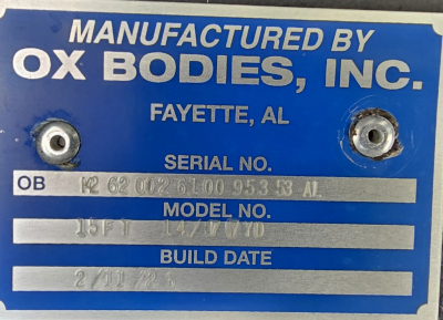 Manufactured by Ox Bodies, Inc. plate with serial number, model and build date data. Text includes 'MANUFACTURED BY OX BODIES, INC. FAYETTE, AL' and fields: SERIAL NO., MODEL NO., BUILD DATE. The serial number appears as 'OB 12 62 002 6100 