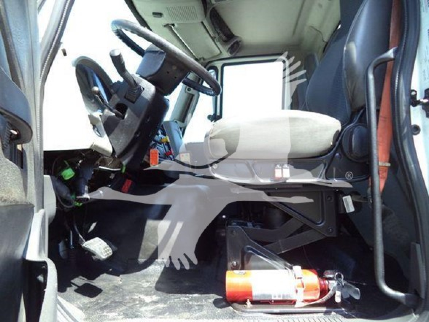 Truck cab interior of a 2016 International Workstar 7600 showing driver seat, steering wheel, and dashboard area.