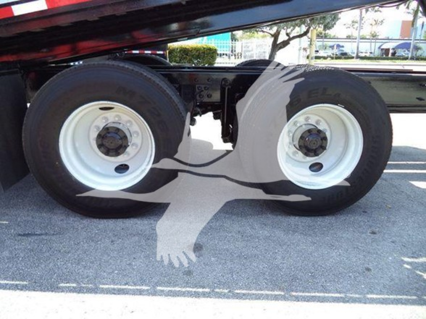 Dual rear truck wheels on a 2016 International Workstar rollback showing white rims and black dual tires with valve stems