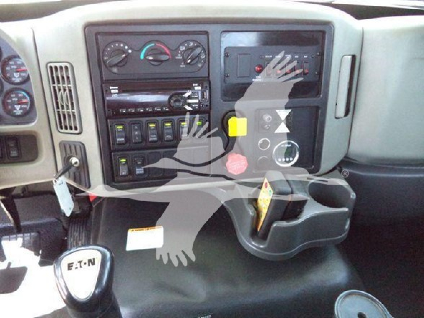Dashboard area of a truck showing control panel with multiple switches, gauges, and a gear shift knob labeled 'E-T-N' visible.