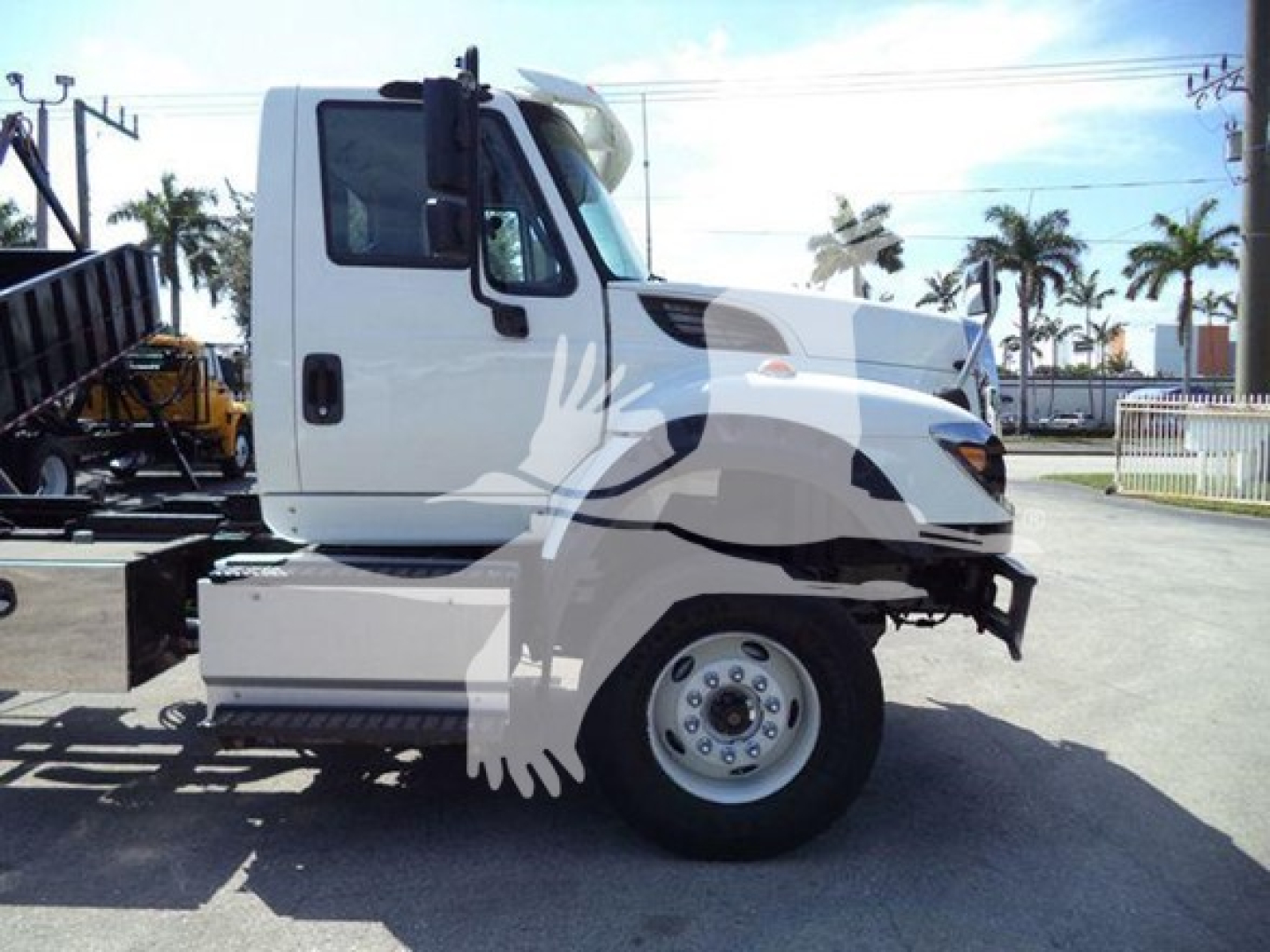 Truck cab side view showing International Workstar 7600 chassis and front wheel
