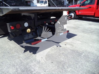 Tractor-tailer rear view showing bumper lights, hydraulic controls, and towing hitch area on a 2016 International Workstar 7600 rollback truck.