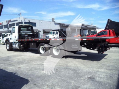 2016 International Workstar 7600 rollback truck shown in side view with flatbed and crane mount.