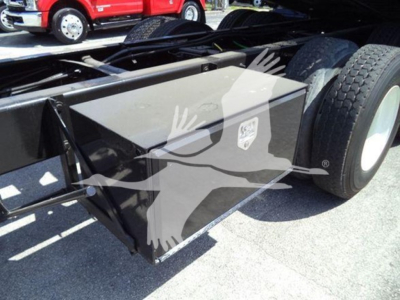 Truck equipment showing a black metal toolbox mounted next to the rear wheels of a 2016 International Workstar 7600 rollback truck.