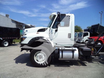 International Workstar 7600 rollback truck side view showing white cab and chassis with fuel tank and dual rear wheels.