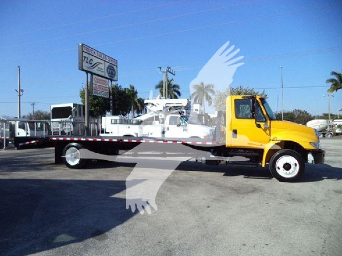 2019 International 4300 auto carrier flatbed tow truck with yellow cab and long flatbed, VIN 3HAMMMML6KL383445, stock T83445, used listing.