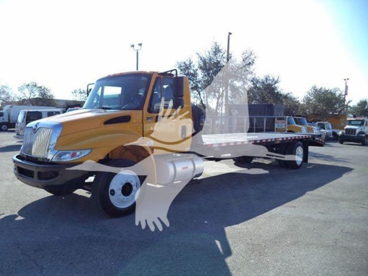 2019 International 4300 auto carrier truck with a yellow cab and long flatbed, VIN 3HAMMMML6KL383445; stock T83445; category Auto Carrier; type Trucks; condition Used.