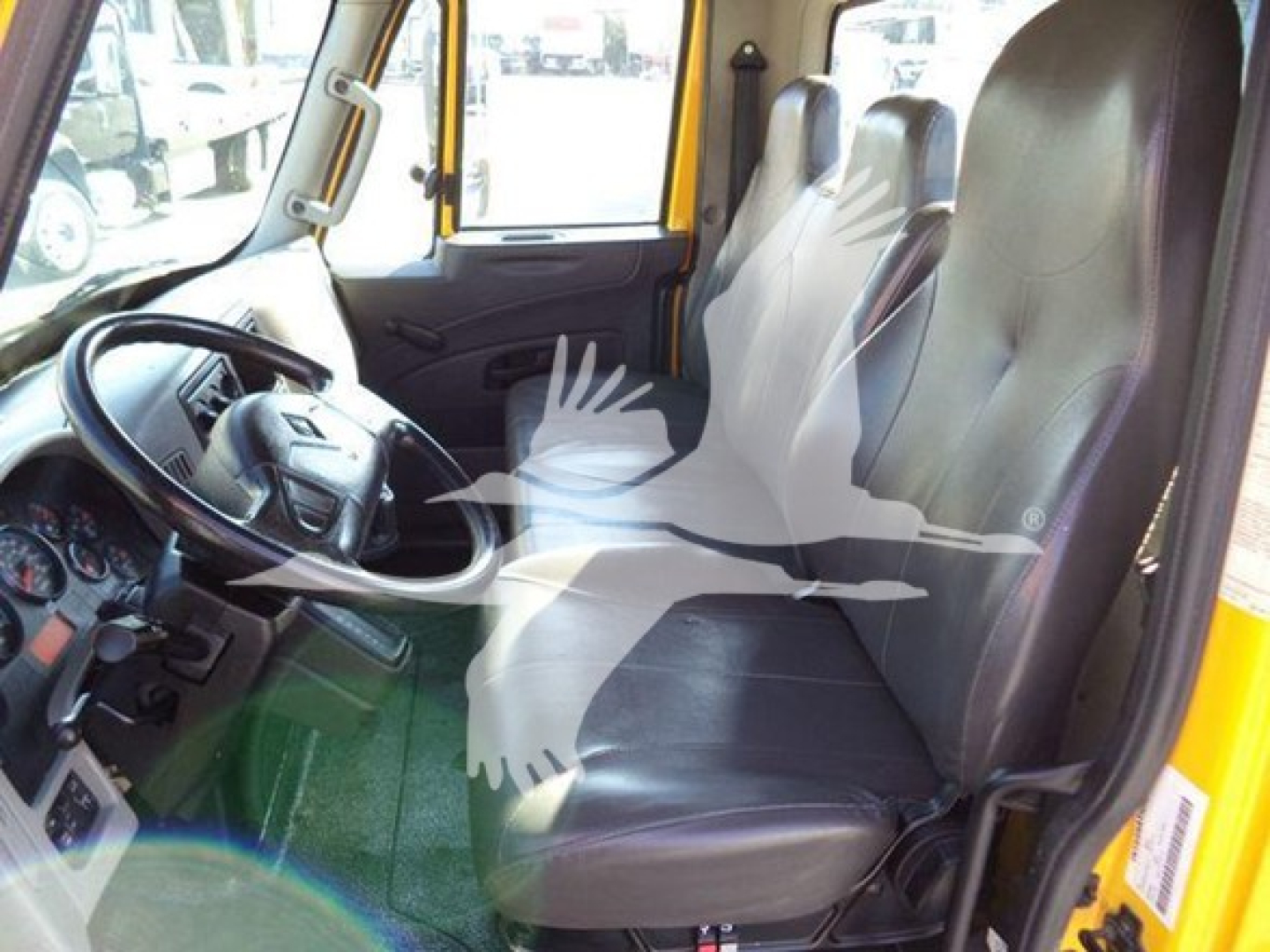Seat area of a 2019 International 4300 truck cab showing driver and passenger seats with steering wheel and dashboard.