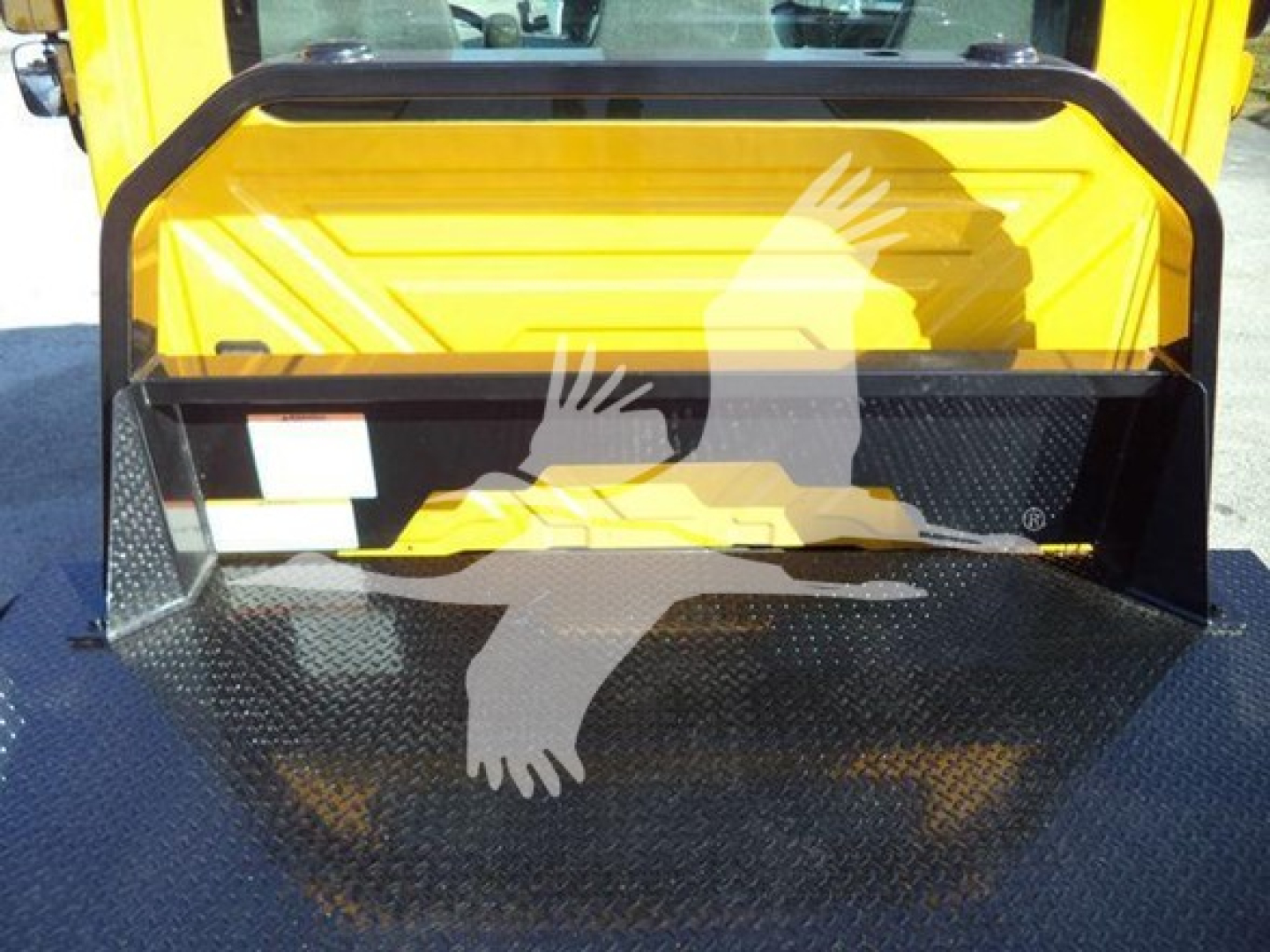 2019 International 4300 auto carrier showing front storage compartment and yellow exterior with black diamond-plate bed.