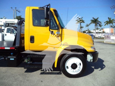 Yellow International 4300 auto carrier truck side view with cab and wheel, VIN 3HAMMMML6KL383445 visible on listing; stock T83445; used vehicle.