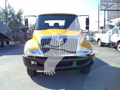 Front view of a yellow 2019 International 4300 auto carrier trucks showing grille, headlights, and bumper with a watermark overlay.