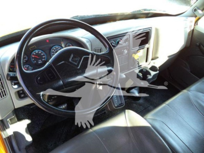 Truck interior showing steering wheel, dashboard, and center console of a 2019 International 4300 auto carrier cab.